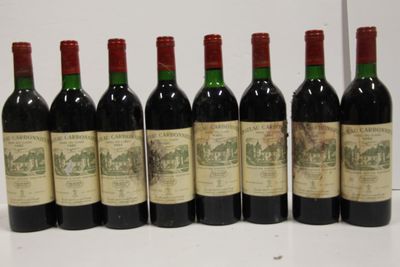 six bottles of red wine lined up in a row on a table