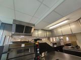 a view of a commercial kitchen with stainless steel appliances