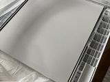a laptop computer sitting on top of a plastic sheet