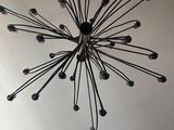 a black and white picture of a chandelier hanging from the ceiling