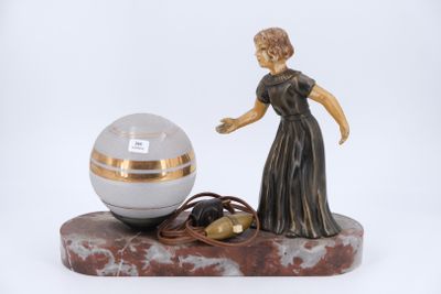a figurine of a woman standing next to a crystal ball