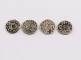 three silver coins with different designs on them on a white surface
