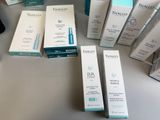 many different types of skin care products sitting on a table