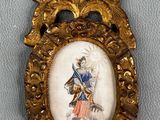 un cadre doré richement décoré, dans lequel figure le portrait d'un homme tenant une épée
