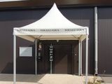 a white tent that is outside of a building