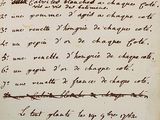 an old manuscript with writing on it and a pen in it