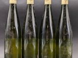 four bottles of wine are lined up in a row