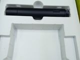 a black pen in a green box on the floor