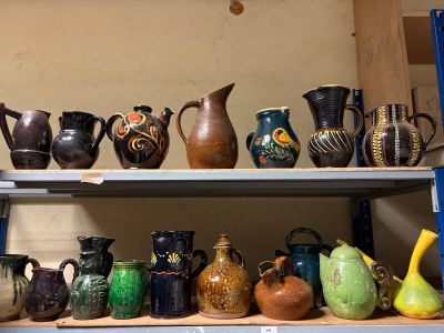 many different types of vases on a shelf