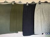 three pairs of skirts hanging on a wall in a row
