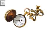 a gold pocket watch with a bow tie on it