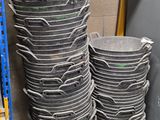 a large stack of buckets sitting on a shelf in a warehouse