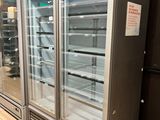 two refrigerators that are sitting in the middle of a store