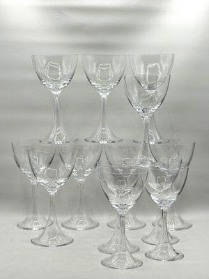 many empty wine glasses sitting on a white table