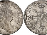 a silver coin with a cross on the front and a crown on the back