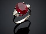 an oval ruby and diamond ring with baguets