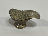 a small metal object that is on a white surface