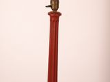 an image of a red lamp post with a light on top of it