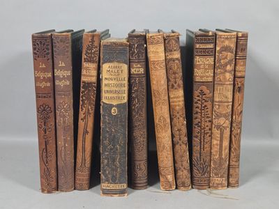 several old books are lined up in a row on a table