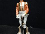 figurine of a man in a military uniform holding a sword