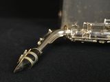 a close up of a saxophone on a black surface