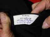 a person holding a label on a black shirt