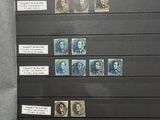 a display of stamps on display in a glass case