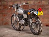 a motorcycle that is parked in front of a brick wall