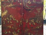 a large red screen with gold designs on it