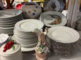 many plates and bowls on a table in a store