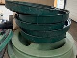 a stack of green pots and pans sitting on a table