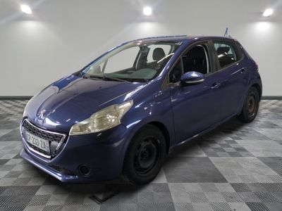 the small blue car is parked in the garage on a checkered floor