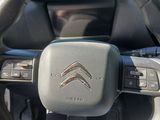 the steering wheel of a car is shown with a dash button