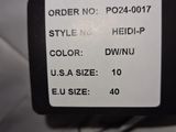 a label on the back of a black and white jacket