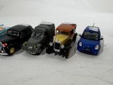 several toy cars are lined up in a row on a white surface