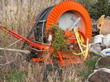 a large orange hose sitting in the middle of a field