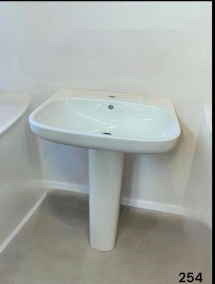 a white sink and a bathtub in a bathroom
