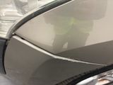 a reflection of a person in a mirror on the side of a car