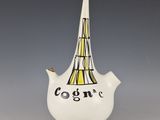 a white vase with a black and yellow design on it