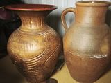 two vases that are sitting on a table