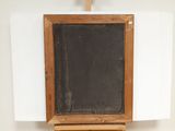 a wooden easel with a chalk board on it