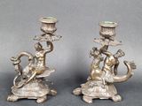 pair of antique silver candlesticks with a lady and a dragon