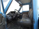 a blue truck that has a steering wheel and a dashboard