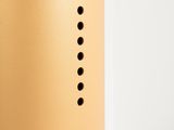 a close up of a metal object with holes in it
