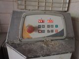 a clock on top of a machine in a kitchen