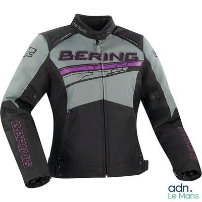 the woman is wearing a black and grey jacket with purple writing on it