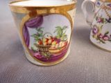 two cups that have been decorated with flowers and fruit