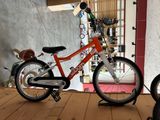 a small child ' s bike that is sitting on a wooden floor