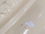 a close up of a white vase on a table
