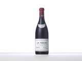 bottle of red wine sitting on top of a white table